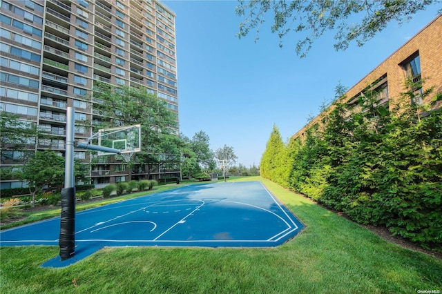 view of basketball court with a lawn