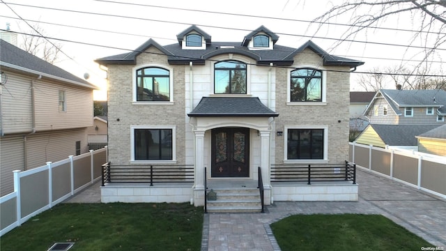 french country style house featuring a front lawn and french doors