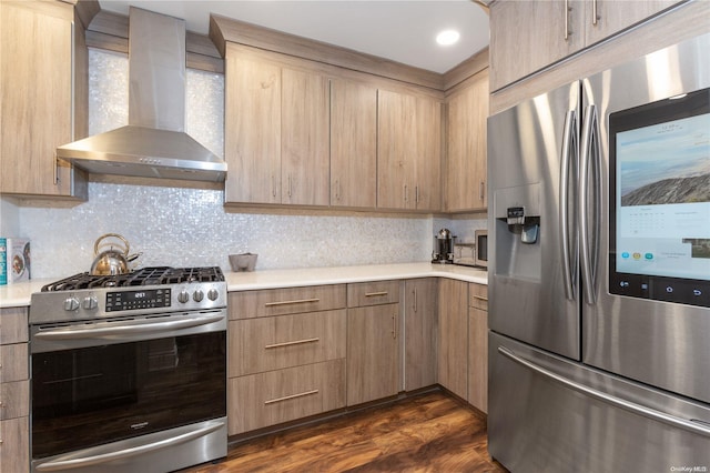 kitchen featuring wall chimney range hood, dark hardwood / wood-style flooring, decorative backsplash, light brown cabinetry, and appliances with stainless steel finishes