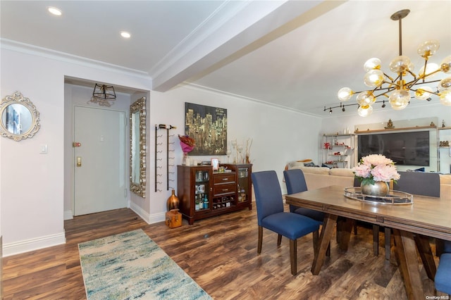 dining room featuring a notable chandelier, ornamental molding, and dark wood-type flooring