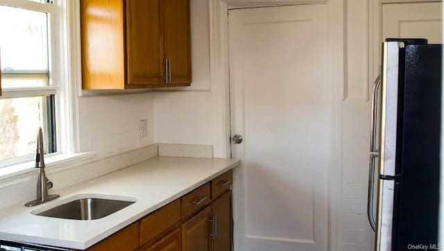 kitchen with sink and stainless steel fridge