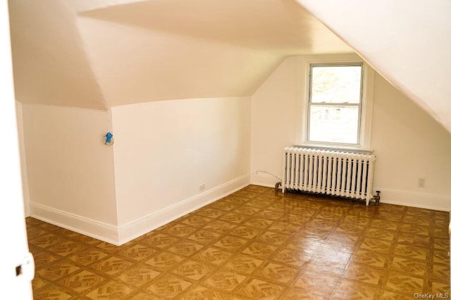 additional living space with lofted ceiling and radiator