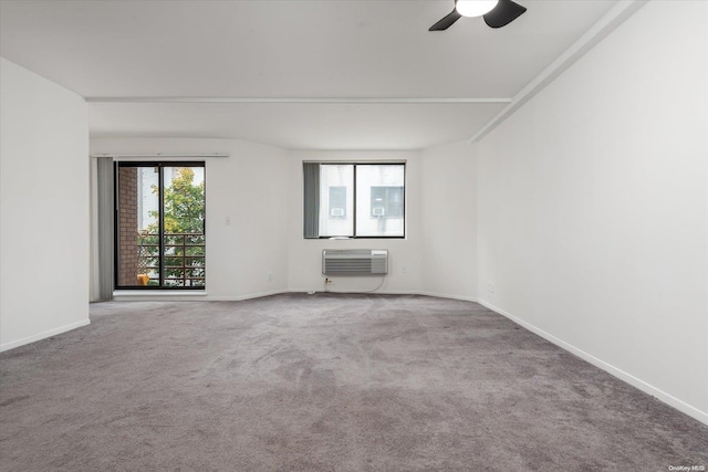 empty room with ceiling fan, carpet floors, and a wall mounted AC