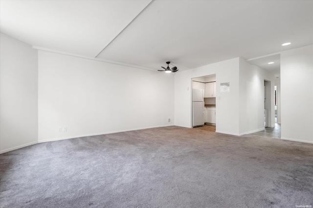 unfurnished living room featuring light colored carpet and ceiling fan