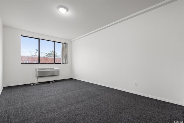 carpeted spare room featuring a wall unit AC