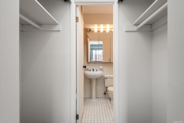 spacious closet with tile patterned flooring and sink