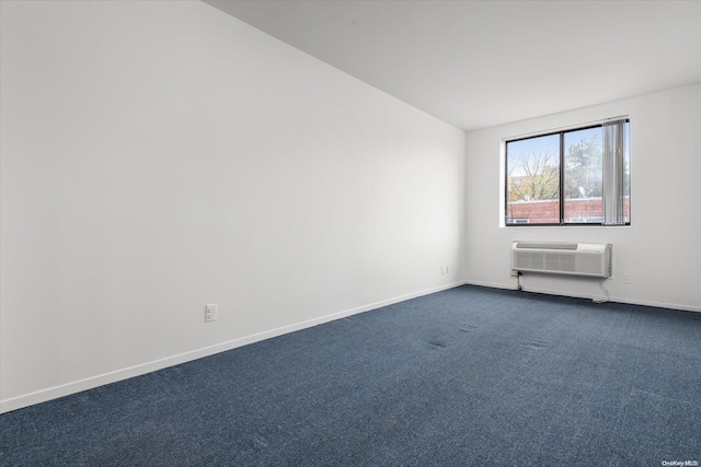 unfurnished room with carpet flooring, a wall unit AC, and lofted ceiling