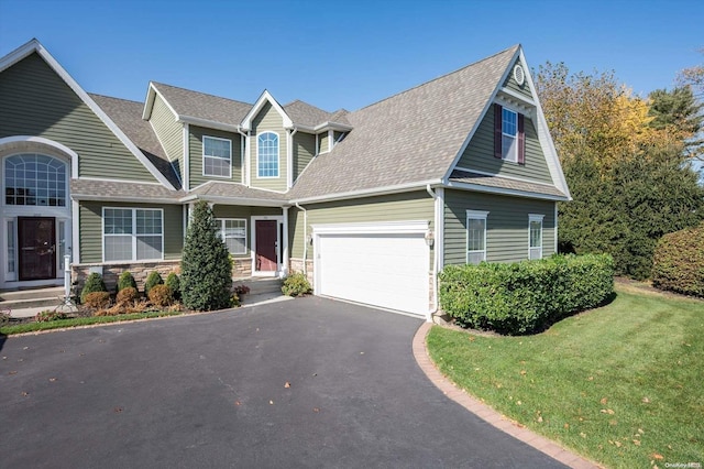 view of front of house featuring a garage and a front lawn