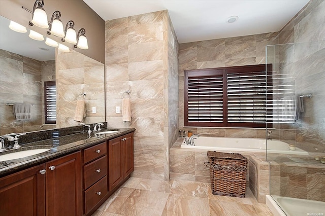 bathroom with plus walk in shower, vanity, and tile walls