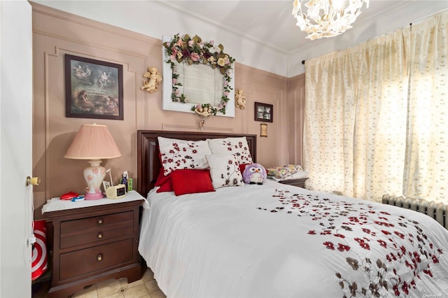 bedroom with radiator, a chandelier, and ornamental molding