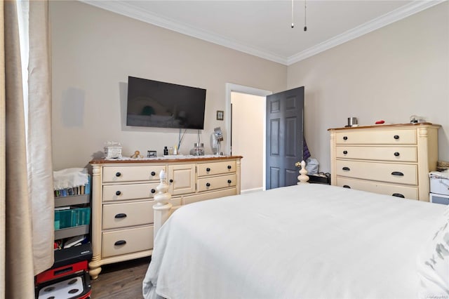 bedroom with dark hardwood / wood-style flooring and ornamental molding