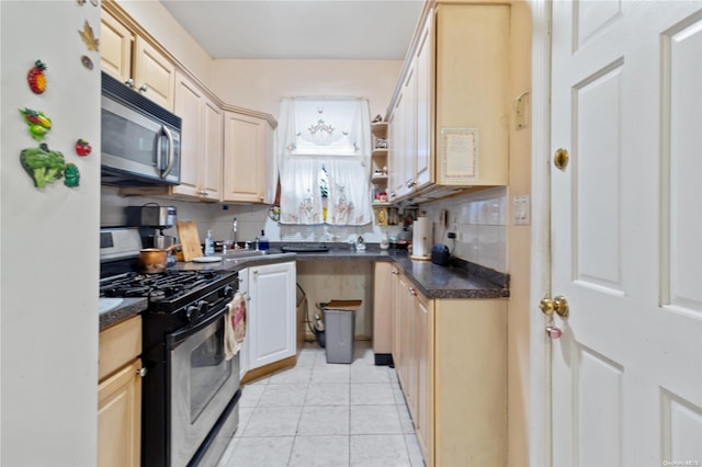 kitchen with decorative backsplash, light brown cabinets, sink, and appliances with stainless steel finishes