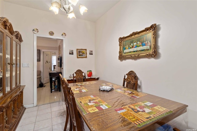 dining space featuring light tile patterned floors and a chandelier