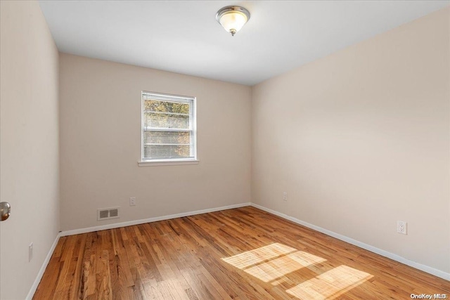 spare room featuring light hardwood / wood-style floors