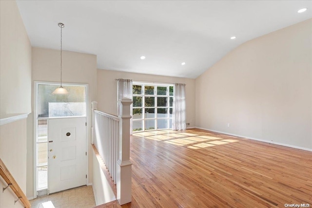 entrance foyer featuring light hardwood / wood-style floors and vaulted ceiling