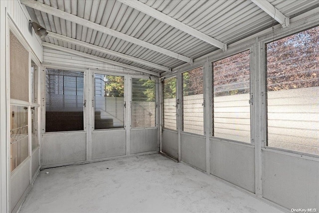 unfurnished sunroom featuring vaulted ceiling