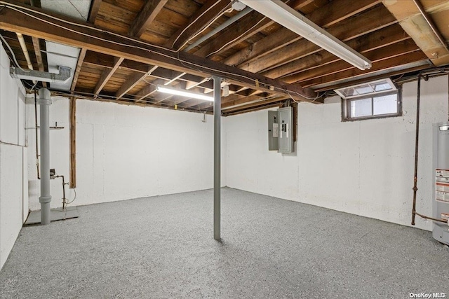 basement featuring electric panel and water heater