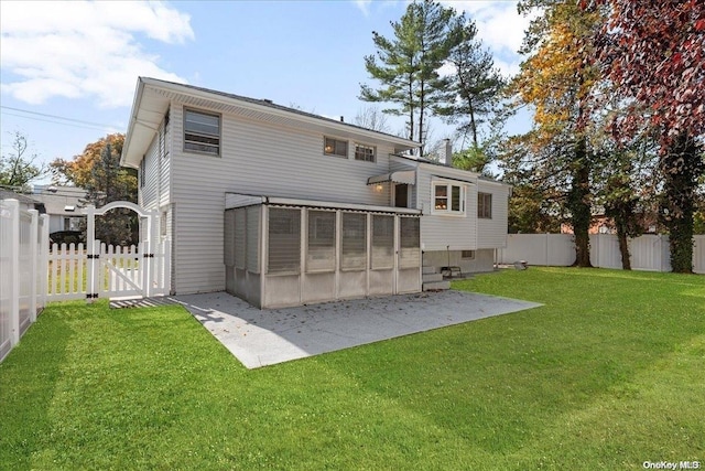 rear view of property with a lawn