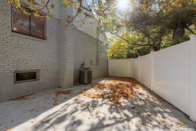 view of side of home featuring a patio and central AC