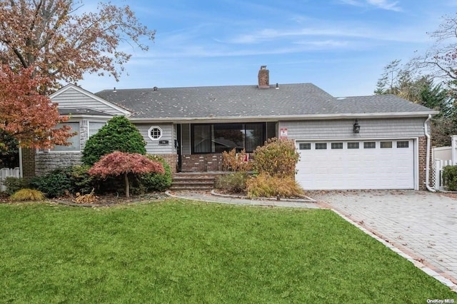 ranch-style home with a garage and a front lawn