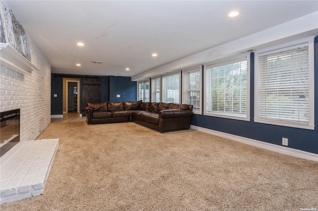 carpeted living room with a fireplace