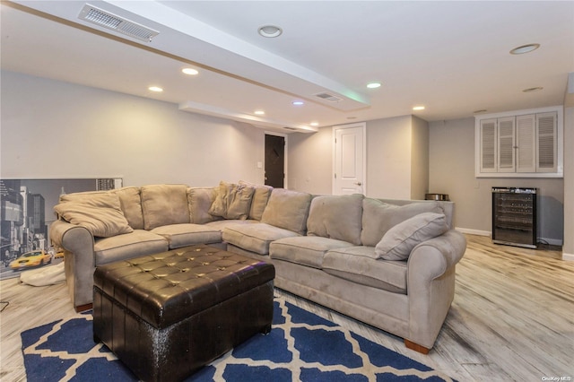 living room with beverage cooler and light wood-type flooring