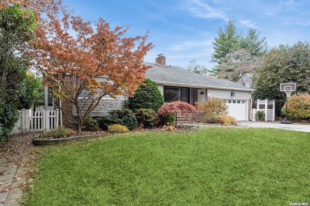 view of front facade with a garage and a front lawn