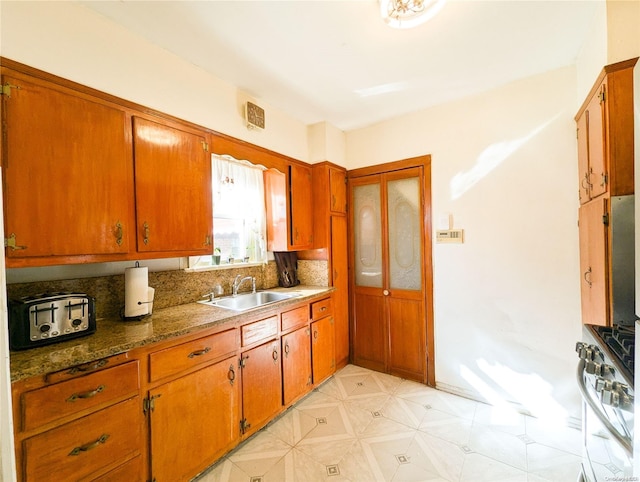 kitchen featuring high end white range and sink