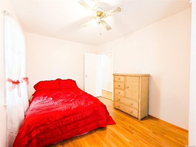 bedroom with ceiling fan and hardwood / wood-style floors