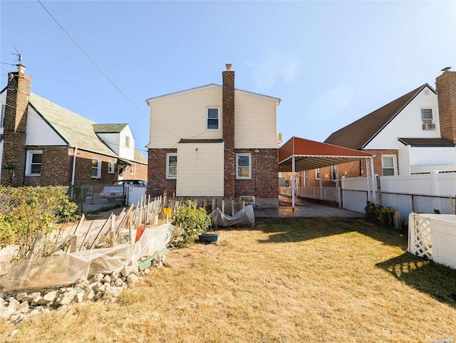 back of house featuring a patio area and a yard