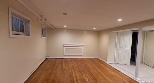 basement with light hardwood / wood-style floors