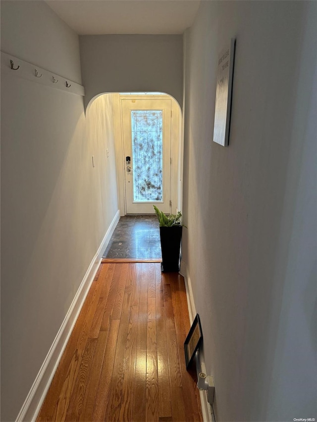 147 E 29th St, Brooklyn, NY 11226 - hall featuring baseboards, wood finished floors, and arched walkways