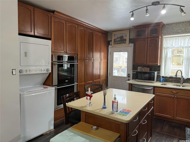 147 E 29th St, Brooklyn, NY 11226 - kitchen with a sink, stainless steel appliances, stacked washing machine and dryer, and light countertops