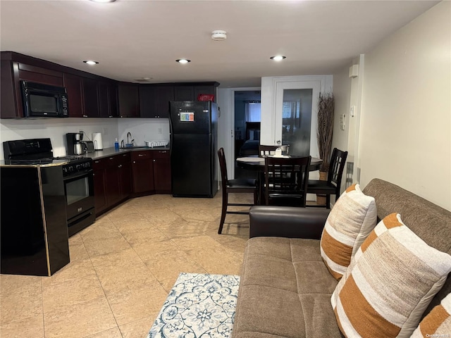 kitchen featuring dark brown cabinets, sink, and black appliances