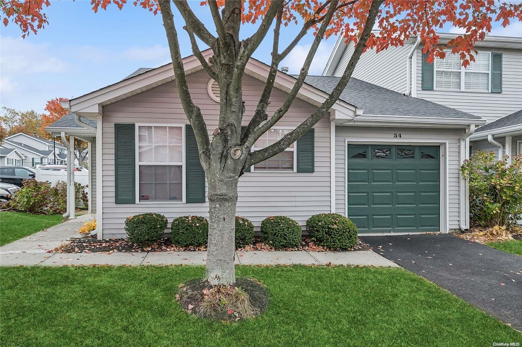 view of front of house with a front yard and a garage