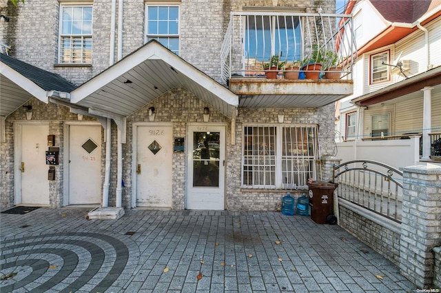 view of exterior entry featuring a balcony