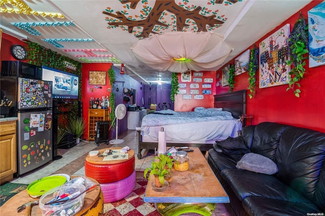 bedroom featuring stainless steel fridge and light tile patterned floors