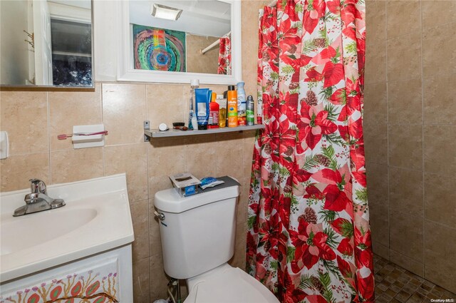 bathroom with a shower with curtain, vanity, toilet, and tile walls