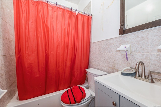 full bathroom featuring shower / tub combo, vanity, tile walls, and toilet