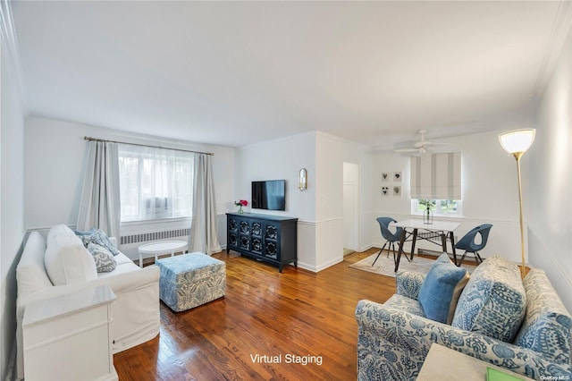 living room featuring wood-type flooring, a wealth of natural light, ornamental molding, and ceiling fan