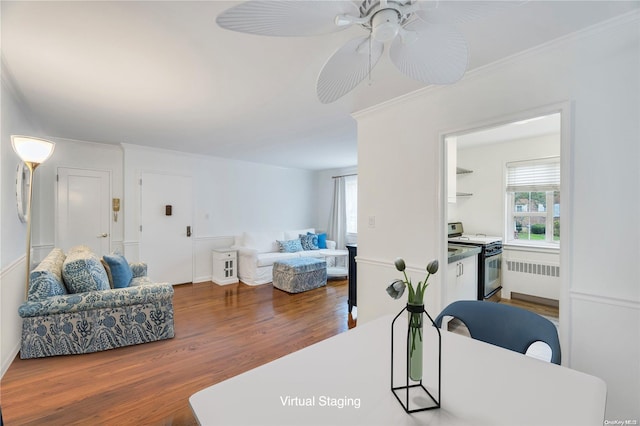 living room featuring ceiling fan, dark hardwood / wood-style flooring, and ornamental molding