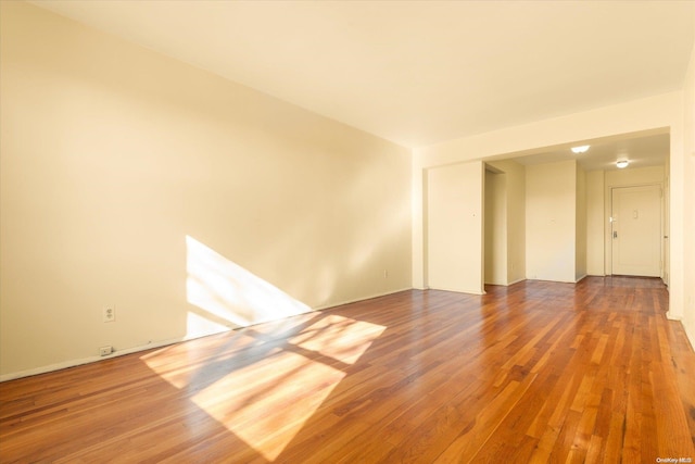 unfurnished room featuring hardwood / wood-style flooring