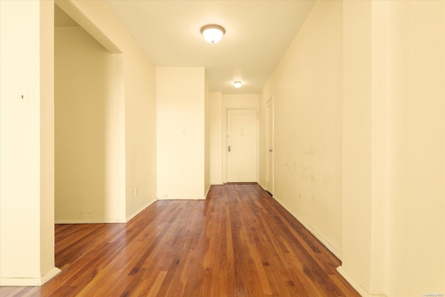 corridor with dark hardwood / wood-style floors