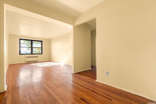 141-16 28th Ave Unit 4C, Flushing, NY 11354 - unfurnished room featuring radiator and wood finished floors