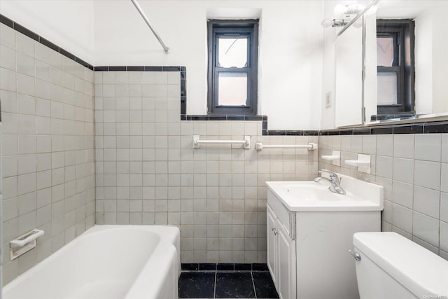 full bathroom with tile patterned floors, vanity, shower / washtub combination, tile walls, and toilet