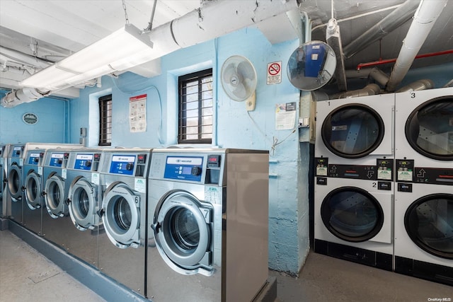 laundry area with stacked washer and clothes dryer and washing machine and clothes dryer