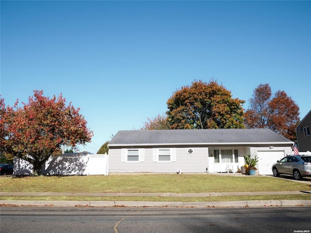 view of front of house with a garage and a front lawn