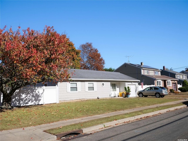 view of front facade featuring a front lawn and a garage