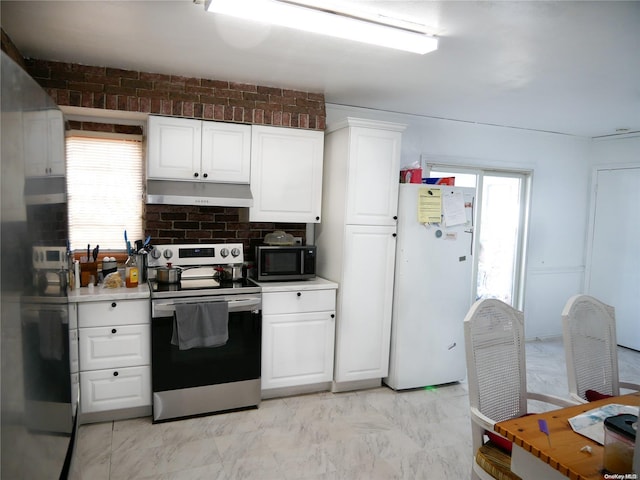 kitchen with white cabinets, appliances with stainless steel finishes, and a healthy amount of sunlight