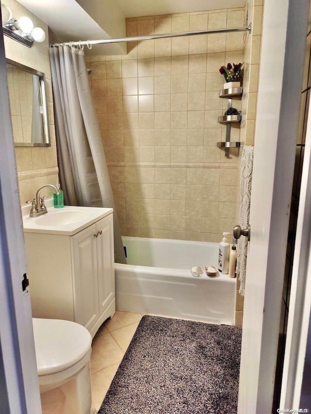 full bathroom with shower / bathtub combination with curtain, tile patterned flooring, vanity, and toilet